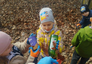 Chłopiec sprząta śmieci.