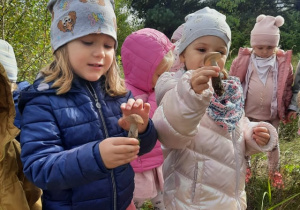 Dziewczynki trzymają w ręku znalezione grzyby